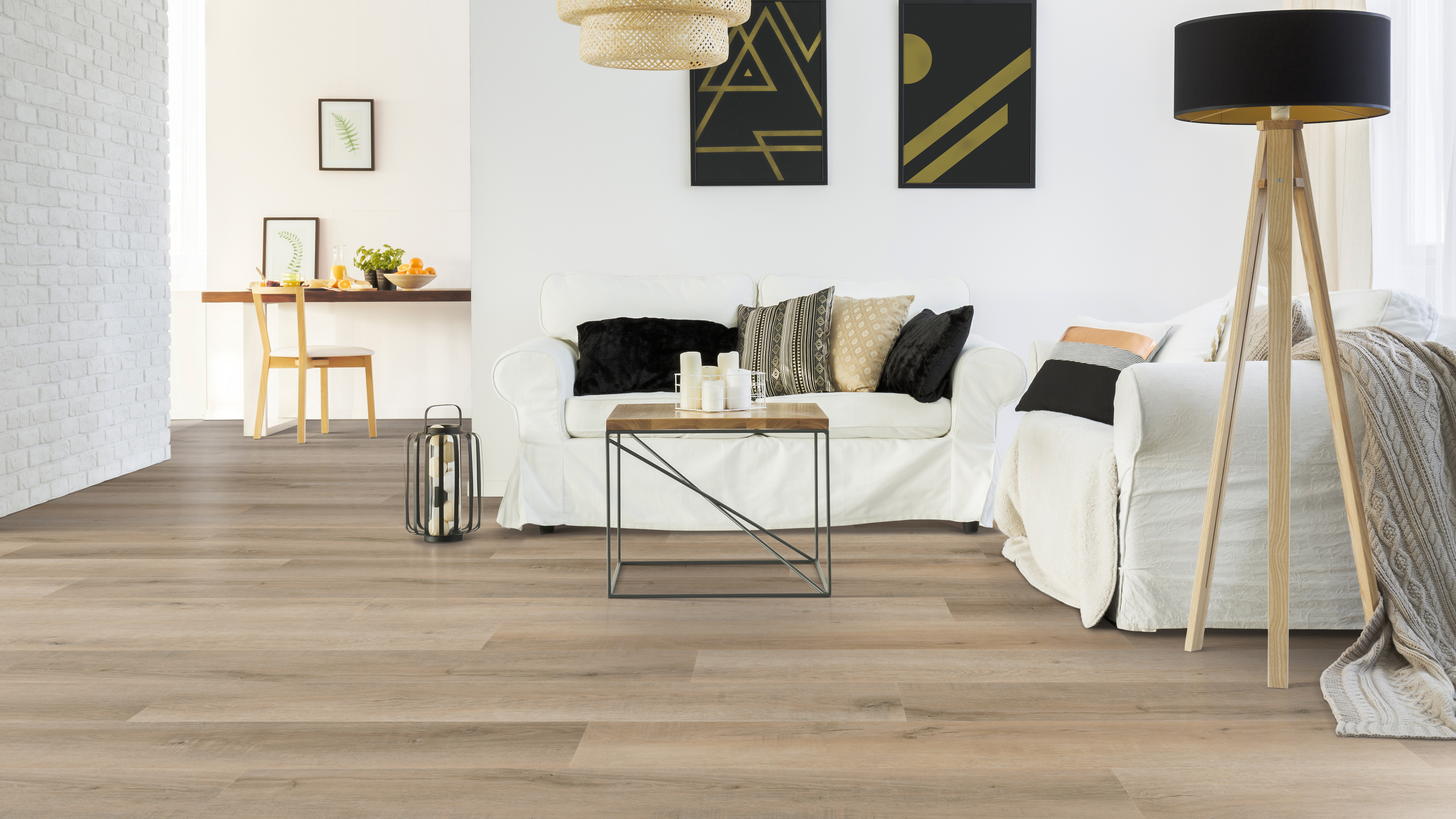 White couch with black and gold accent decor and vinyl flooring