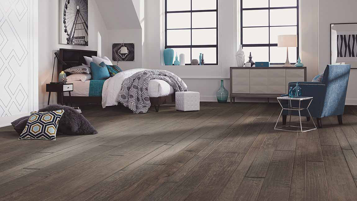 Bedroom setting with hardwood flooring and accent colors of teal